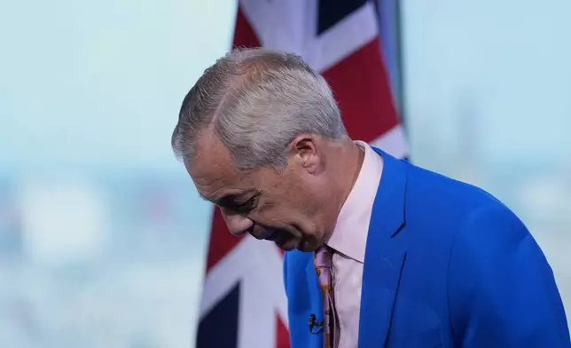 Reform UK leader Nigel Farage gestures as he makes a statement to the media at the party headquarters in Millbank, central London, Tuesday July 7, 2026. (Gareth Fuller/PA via AP)