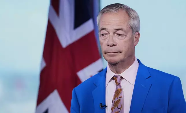 Reform UK leader Nigel Farage looks on as he makes a statement to the media at the party headquarters in Millbank, central London, Tuesday July 7, 2026. (Gareth Fuller/PA via AP)