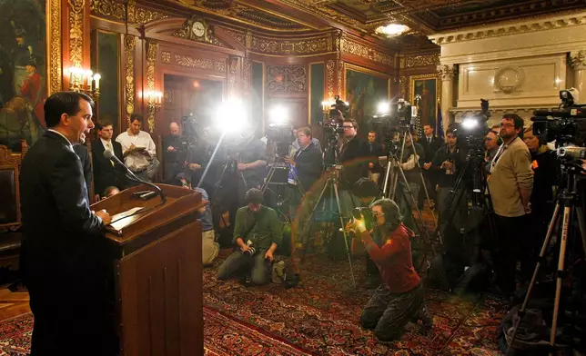 FILE - Wisconsin Gov. Scott Walker talks to the media Feb. 17, 2011, at the State Capitol in Madison, Wis., in response to several state Senators leaving the state to block his bill that would eliminate collective bargaining rights for many state workers. (AP Photo/Andy Manis, File)