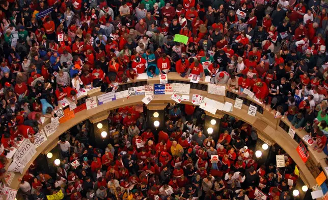 FILE - Protestors of Wisconsin Gov. Scott Walker's bill to eliminate collective bargaining rights for many state workers pack the rotunda at the State Capitol Feb. 17, 2011, in Madison, Wis. (AP Photo/Andy Manis, File)