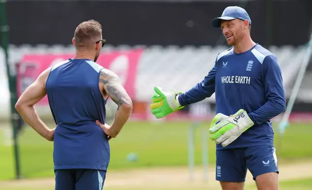 England's Jos Butler, right, talks to head coach Brendon McCullum during a nets session in Nottingham, England, Monday July 6, 2026. (David Davies/PA via AP)