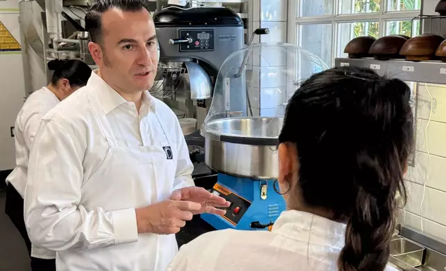 Chef Val Cantu, co-owner of Californios, speaks with a member of the staff in San Francisco on Thursday, July 16, 2026. (AP Photo/Haven Daley)