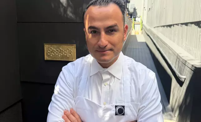 Chef Val Cantu, co-owner of Californios, poses in front of his three Michelin Star plaque in San Francisco on Thursday, July 16, 2026. (AP Photo/Haven Daley)