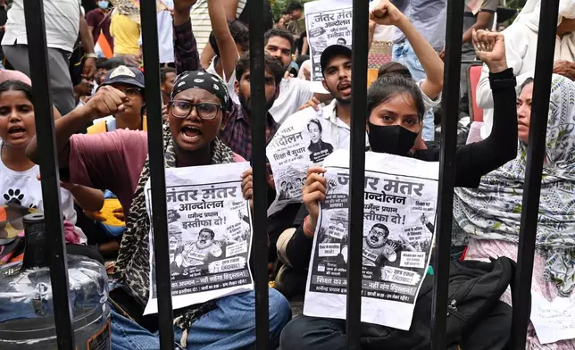 Protesters shout slogans as they carry posters asking for the resignation of India's Minister of Education Dharmendra Pradhan at a protest led by Cockroach Janta Party in New Delhi, India, Wednesday, July 22, 2026. (AP Photo/Vipin)