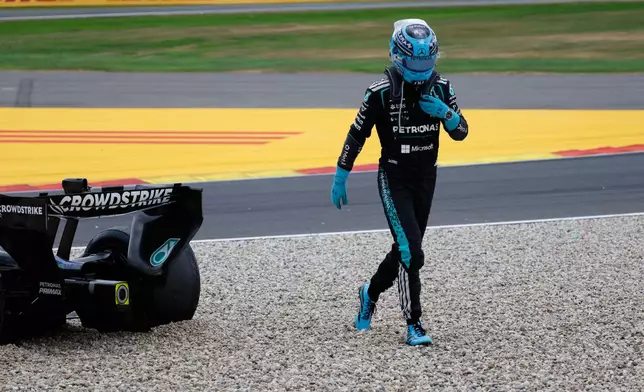 Mercedes driver George Russell of Britain gets out of his car after going off the track during the Formula One Grand Prix at the Spa-Francorchamps racetrack in Spa, Belgium, Sunday, July 19, 2026. (AP Photo/Geert Vanden Wijngaert)