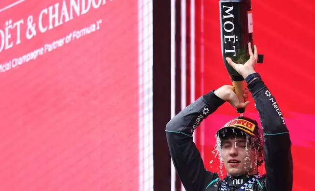 Mercedes driver Andrea Kimi Antonelli of Italy celebrates on the podium after winning the Formula One Grand Prix at the Spa-Francorchamps racetrack in Spa, Belgium, Sunday, July 19, 2026. (AP Photo/Omar Havana)