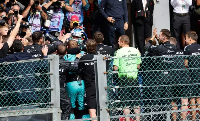 Mercedes driver Andrea Kimi Antonelli of Italy, center, is congratulated by his team after winning the Formula One Grand Prix at the Spa-Francorchamps racetrack in Spa, Belgium, Sunday, July 19, 2026. (AP Photo/Geert Vanden Wijngaert)