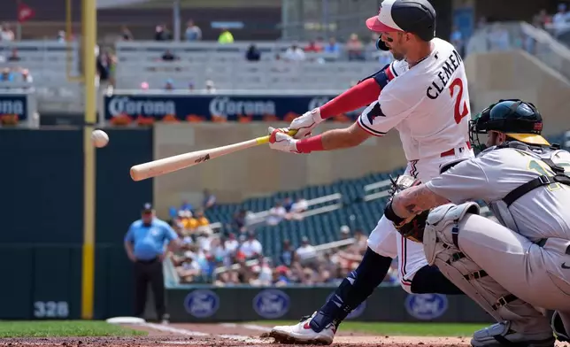 Minnesota Twins' Kody Clemens (2) hits an RBI triple against the Athletics in the first inning of a baseball game Sunday, July 26, 2026, in Minneapolis. Due to a throwing error, Clemens also scored on the play. (AP Photo/Bruce Kluckhohn)