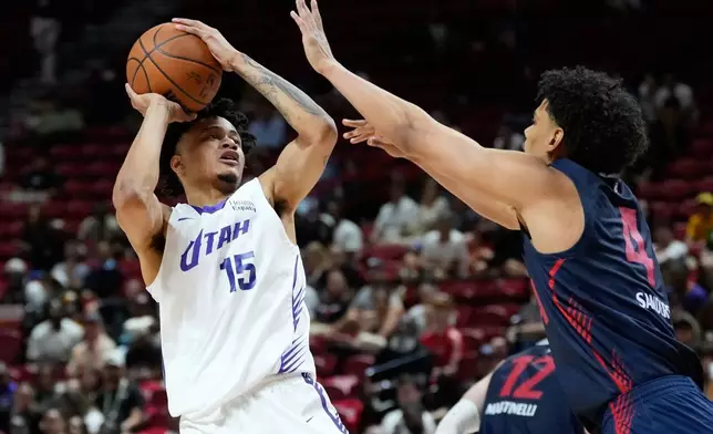 Utah Jazz's Trey Alexander shoots over LA Clippers' Kobe Sanders during the second half of an NBA Summer League basketball game Sunday, July 12, 2026, in Las Vegas. (AP Photo/John Locher)
