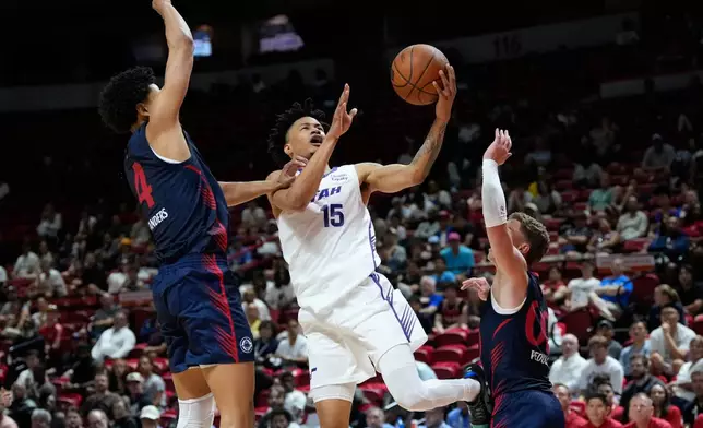 Utah Jazz's Trey Alexander shoots against LA Clippers' Kobe Sanders, left, and LA Clippers' Sean Pedulla during the second half of an NBA Summer League basketball game Sunday, July 12, 2026, in Las Vegas. (AP Photo/John Locher)