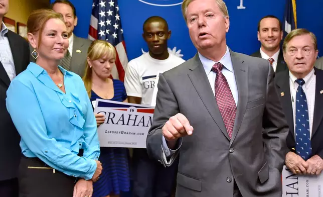 FILE - Republican presidential candidate, Sen. Lindsey Graham, R-S.C., accompanied by his sister Darline, left, speaks at the GOP headquarters in Columbia, S.C., Sept. 1, 2015, where he filed for the South Carolina Presidential Primary. (AP Photo/Richard Shiro, File)