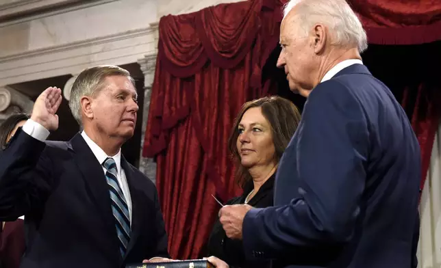 FILE - Vice President Joe Biden, right, administers the Senate oath to Sen. Lindsey Graham, R-S.C., left, as Graham's sister Darline Graham looks on during a ceremonial re-enactment swearing-in ceremony, Jan. 6, 2015, in the Old Senate Chamber on Capitol Hill in Washington. (AP Photo/Susan Walsh, File)