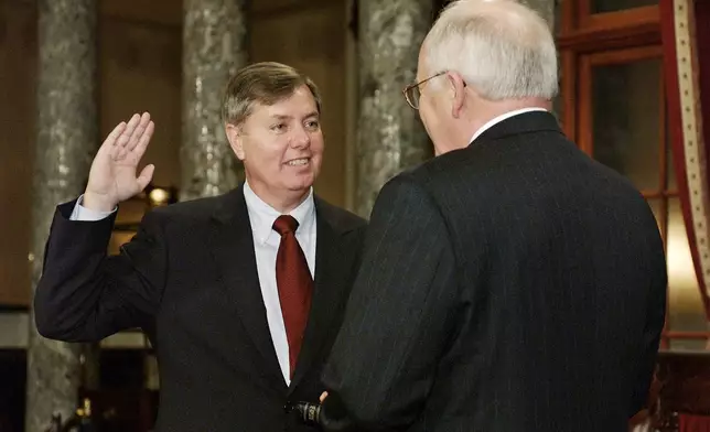 FILE - Sen. Lindsey Graham, R-S.C., takes the oath of office with Vice President Dick Cheney, right, during a re-enactment swearing-in ceremony in the Old Senate Chamber on Capitol Hill in Washington, Jan. 7, 2003, following his election to the Senate. (AP Photos/Evan Vucci, File)