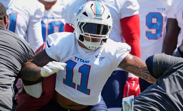 Tennessee Titans defensive end Jermaine Johnson II (11) runs though a drill during the NFL football team's training camp Thursday, July 30, 2026, in Nashville, Tenn. (AP Photo/George Walker IV)