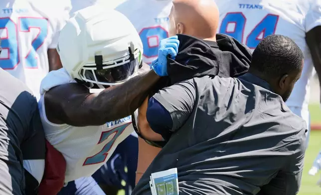 Tennessee Titans defensive end Oluwafemi Oladejo (7) runs through a drill during the NFL football team's training camp Thursday, July 30, 2026, in Nashville, Tenn. (AP Photo/George Walker IV)