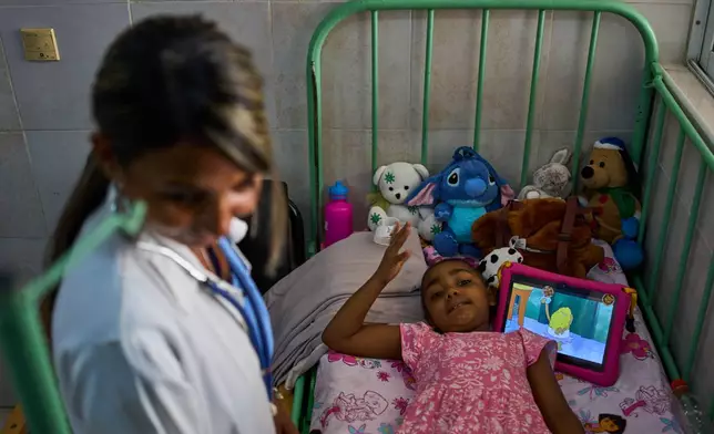 Karolina Silva Matis, a 6-year-old oncology patient, is examined by Dr. Yolainy Romero Rodriguez at the National Institute of Oncology and Radiobiology in Havana, Cuba, Wednesday, June 24, 2026. (AP Photo/Ramon Espinosa)