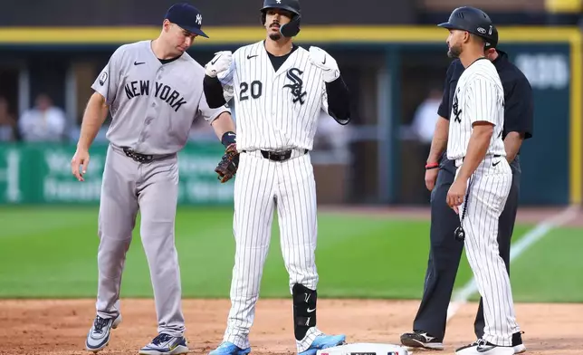 Chicago White Sox's Miguel Vargas (20) gestures after hitting a single as New York Yankees first baseman Paul Goldschmidt, left, and Chicago White Sox first base Jose Leger, right, look on during the fourth inning of a baseball game in Chicago, Wednesday, July 29, 2026. (AP Photo/Jessie Alcheh)