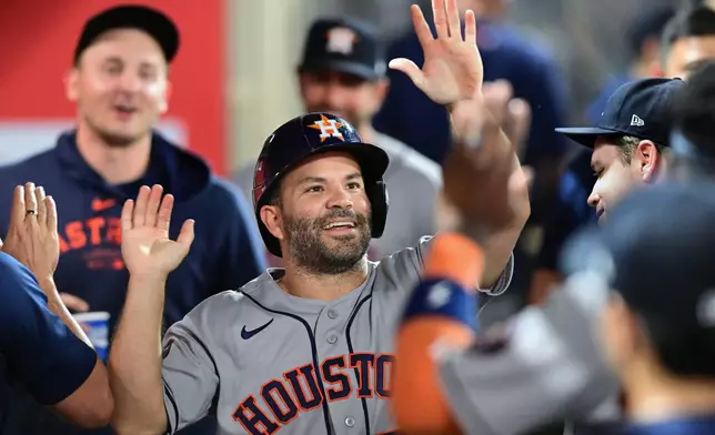 Houston Astros Jose Altuve (27) celebrates after scoring a run against the Los Angeles Angels during the seventh inning of a baseball game Wednesday, July 29, 2026, in Anaheim, Calif. (AP Photo/Wally Skalij)