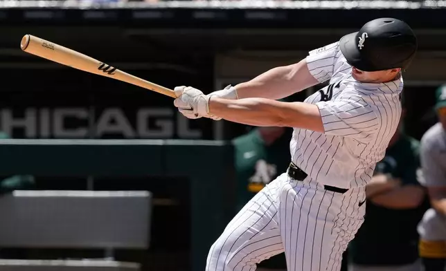 Chicago White Sox's Kyle Teel hits a two-run single during the first inning of a baseball game against the Athletics in Chicago, Sunday, July 12, 2026. (AP Photo/Nam Y. Huh)