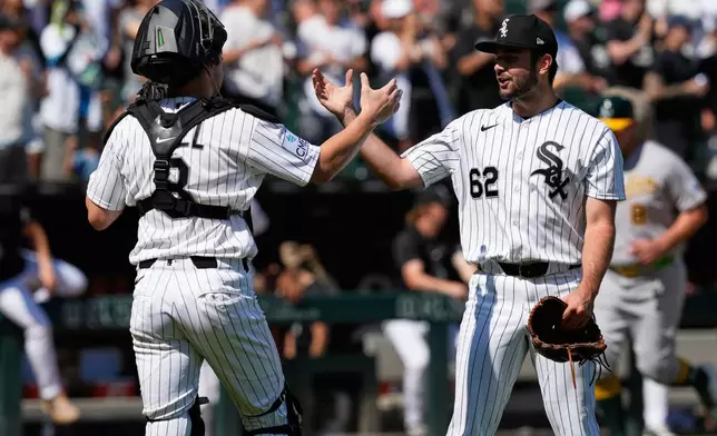 Chicago White Sox catcher Kyle Teel, left, celebrates with relief pitcher Tyler Schweitzer after the White Sox defeated the Athletics in a baseball game in Chicago, Sunday, July 12, 2026. (AP Photo/Nam Y. Huh)