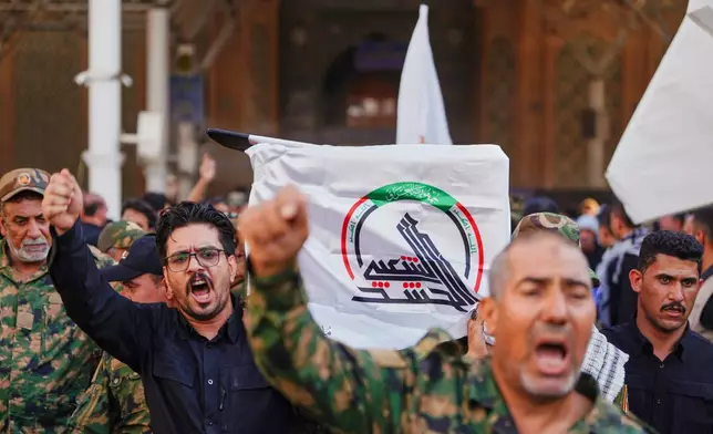Mourners carry a coffin draped with a cloth bearing the emblem of Iraq's Popular Mobilization Forces during a funeral for Popular Mobilization Forces fighters killed in airstrikes on PMF bases in Najaf, Iraq, Thursday, July 30, 2026. (AP Photo/Hadi Mizban)