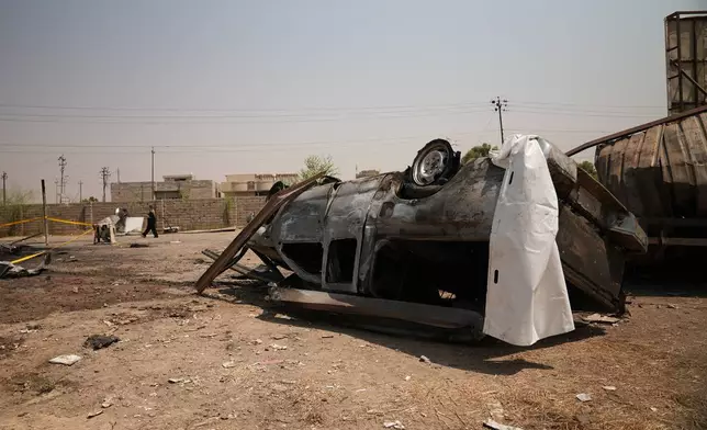 A damaged vehicle at the site of an airstrike on a Popular Mobilization Forces base in Mosul, Iraq, Wednesday, July 29, 2026. (AP Photo/Farid Abdulwahed)