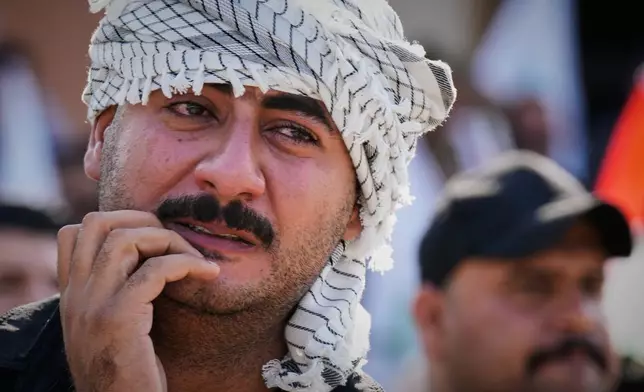 A mourner weeps during a group funeral for Iranian advisers and Popular Mobilization Forces fighters killed in airstrikes on bases belonging to Iraq's Popular Mobilization Forces, a coalition of predominantly Shiite militias that includes Iran-backed groups, in Mosul, Iraq, Wednesday, July 29, 2026. (AP Photo/Hadi Mizban)
