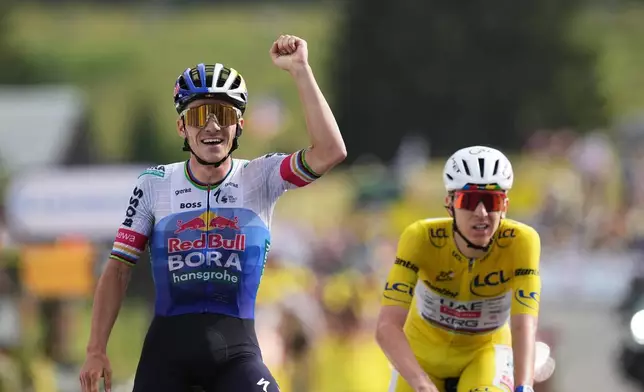 Belgium's Remco Evenepoel celebrates as he crosses the finish line ahead Slovenia's Tadej Pogacar to win the fifteenth stage of the Tour de France cycling race, from Champagnole to the Plateau de Solaison, France, Sunday, July 19, 2026. (AP Photo/Thibault Camus)