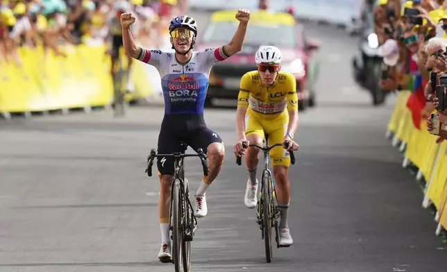 Belgium's Remco Evenepoel celebrates as he crosses the finish line ahead Slovenia's Tadej Pogacar to win the fifteenth stage of the Tour de France cycling race, from Champagnole to the Plateau de Solaison, France, Sunday, July 19, 2026. (AP Photo/Thibault Camus)
