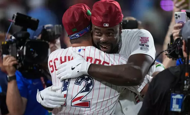 St. Louis Cardinals' Jordan Walker embraces Philadelphia Phillies' Kyle Schwarber after Walker won the MLB baseball All-Star Home Run Derby, Monday, July 13, 2026, in Philadelphia. (AP Photo/Matt Slocum)