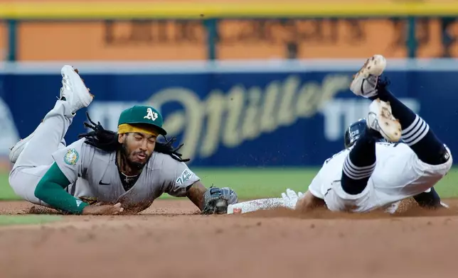 Athletics second baseman Joshua Kuroda-Grauer (44) makes a diving tag to get the force out on Detroit Tigers' Zach McKinstry during the sixth inning of a baseball game Wednesday, July 8, 2026, in Detroit. (AP Photo/Duane Burleson)