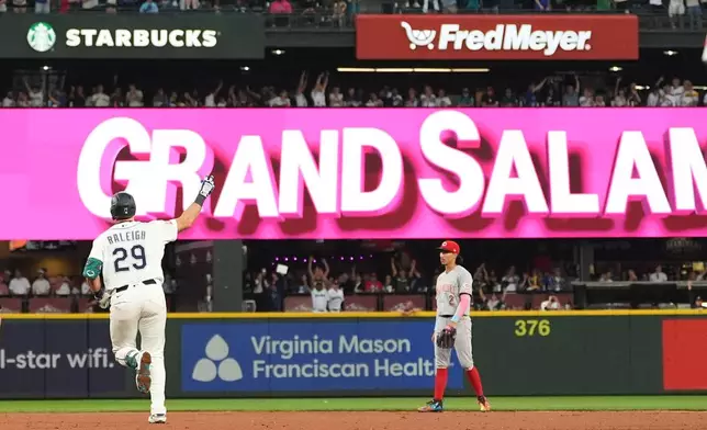 Seattle Mariners' Cal Raleigh jogs the bases after hitting a grand slam as Cincinnati Reds second baseman Edwin Arroyo (2) looks on during the seventh inning of a baseball game, Monday, July 20, 2026, in Seattle. (AP Photo/Lindsey Wasson)