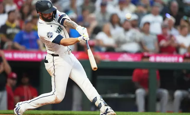 Seattle Mariners' Weston Wilson hits an RBI double to score Luke Raley against the Cincinnati Reds during the seventh inning of a baseball game, Monday, July 20, 2026, in Seattle. (AP Photo/Lindsey Wasson)