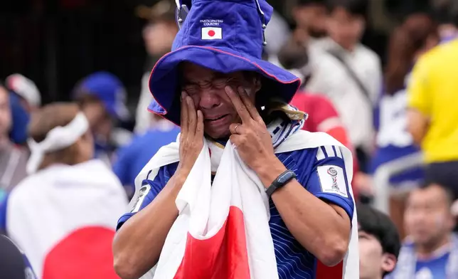 A Japan supporter reacts after the World Cup round of 32 soccer match between Brazil and Japan in Houston, Monday, June 29, 2026. (AP Photo/David J. Phillip)