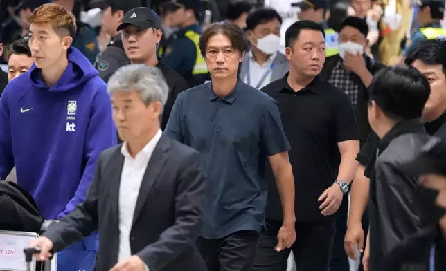 South Korea's soccer head coach Hong Myung-bo, center, who has resigned following the team's early elimination from the World Cup, arrives at the Incheon International Airport in Incheon, South Korea, Tuesday, June 30, 2026. (AP Photo/Ahn Young-joon)
