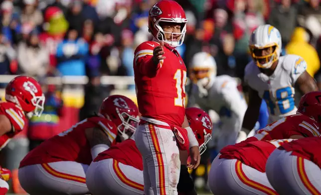 FILE - Kansas City Chiefs quarterback Patrick Mahomes directs his team against the Los Angeles Chargers during an NFL football game, Dec, 14, 2025, in Kansas City, Mo. (AP Photo/Ed Zurga, File)
