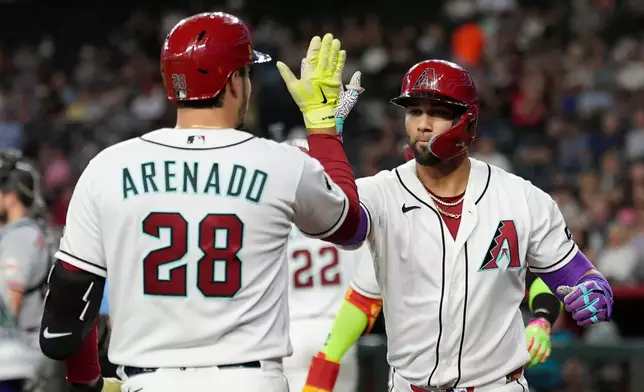 Arizona Diamondbacks' Lourdes Gurriel Jr., right, celebrates his three-run home run against the San Francisco Giants with Diamondbacks' Nolan Arenado (28) during the first inning of a baseball game, Tuesday, June 30, 2026, in Phoenix. (AP Photo/Ross D. Franklin)