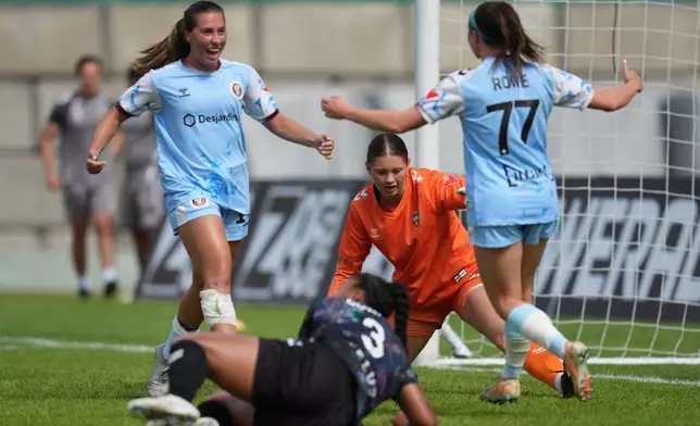 Toronto AFC's Lauren Rowe (77) celebrates with teammate Sarah Stratigakis, left, after scoring a goal past Vancouver Rise FC's Jessica Wulf during a NSL match in Burnaby, British Columbia, Sunday, June 28, 2026. (AP Photo/Abbie Parr)