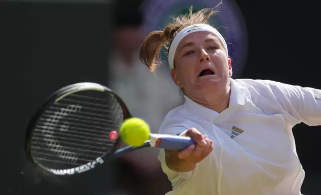 Karolina Muchova of the Czech Republic returns the ball to Coco Gauff of the United States in their semifinal women's singles match at the Wimbledon Tennis Championships in London, Thursday, July 9, 2026. (AP Photo/Kin Cheung)