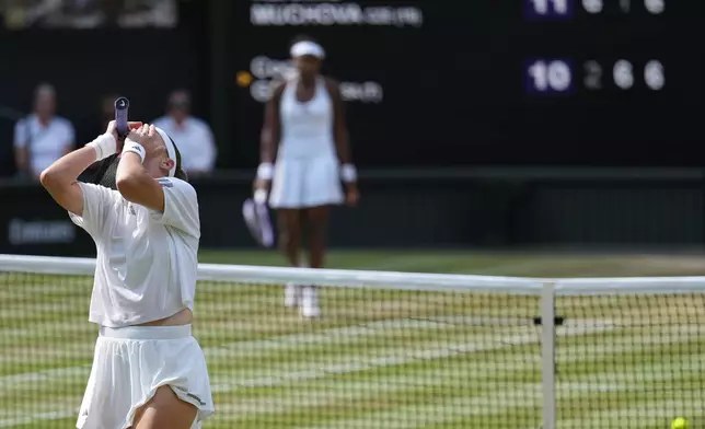 Karolina Muchova of the Czech Republic celebrates her victory against Coco Gauff of the United States, background, in their semifinal women's singles match at the Wimbledon Tennis Championships in London, Thursday, July 9, 2026. (AP Photo/Kirsty Wigglesworth)