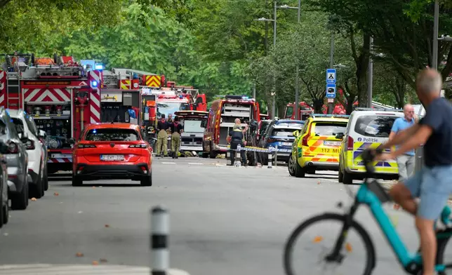 Emergency workers on the street after a fire broke out in an apartment block in Linkeroever, Belgium, Wednesday, July 1, 2026. (AP Photo/Virginia Mayo)