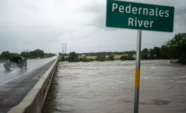 The Pedernales River floods underneath State Highway 87 on Thursday, July 16, 2026, in Fredericksburg, Texas. (AP Photo/Joel Angel Juarez)