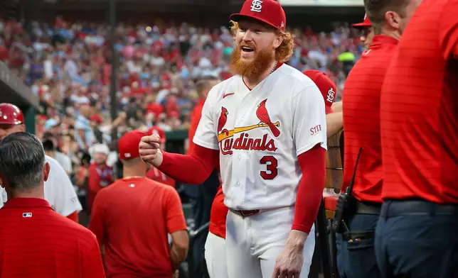 St. Louis Cardinals' Dustin May smiles as he talks with teammates in the dugout during the fifth inning of a baseball game against the Chicago Cubs Wednesday, July 29, 2026, in St. Louis. (AP Photo/Scott Kane)