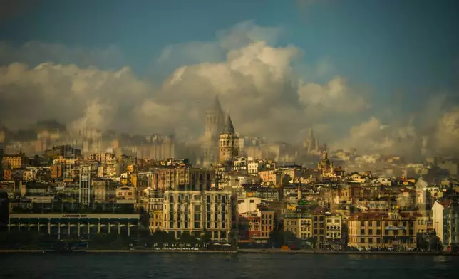 Photographed through the window of a ferry, the Galata Tower stands in Istanbul, Turkey, on the bank of the Bosphorus Strait, Thursday, July 2, 2026. (AP Photo/Emrah Gurel)