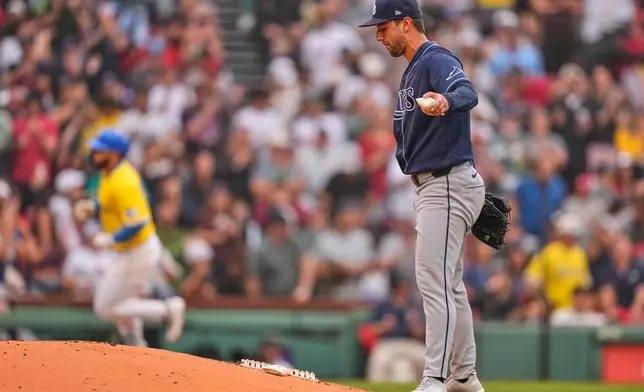 Tampa Bay Rays' Ian Seymour, right, prepares for the next batter as Boston Red Sox's Wilyer Abreu, back left, rounds the bases on a solo home run in the third inning of a baseball game, Saturday, July 18, 2026, in Boston. (AP Photo/Charles Krupa)
