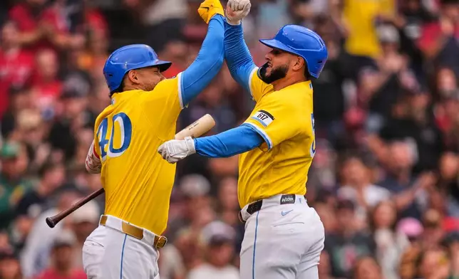 Boston Red Sox's Wilyer Abreu, right, is congratulated by Willson Contreras after hitting a solo home run in the third inning of a baseball game against the Tampa Bay Rays, Saturday, July 18, 2026, in Boston. (AP Photo/Charles Krupa)