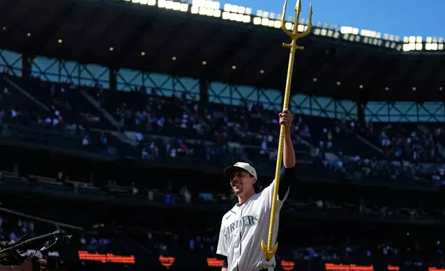 Seattle Mariners starting pitcher Logan Gilbert lifts the trident to celebrate a win over the Toronto Blue Jays in a baseball game, Saturday, July 4, 2026, in Seattle. (AP Photo/Lindsey Wasson)