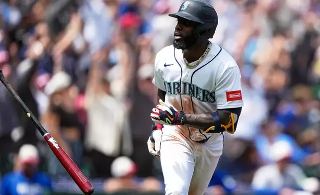 Seattle Mariners' Randy Arozarena reacts after hitting a grand slam against the Toronto Blue Jays during the second inning of a baseball game, Saturday, July 4, 2026, in Seattle. (AP Photo/Lindsey Wasson)