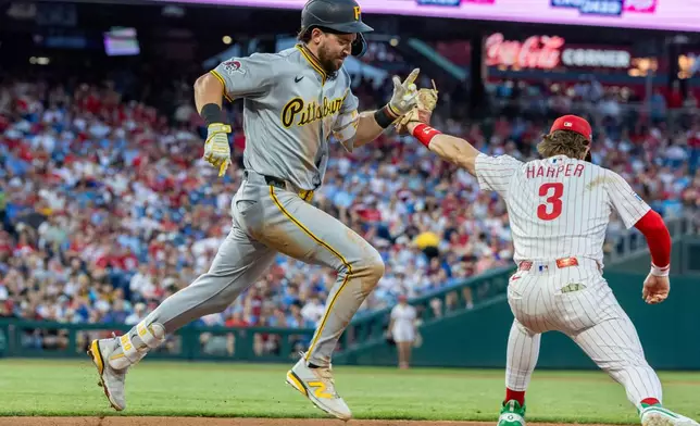 Pittsburgh Pirates' Jared Triolo is out at first as Philadelphia Phillies first baseman Bryce Harper (3) tags the base in the seventh inning of a baseball game, Tuesday, June 30, 2026, in Philadelphia. (AP Photo/Laurence Kesterson)