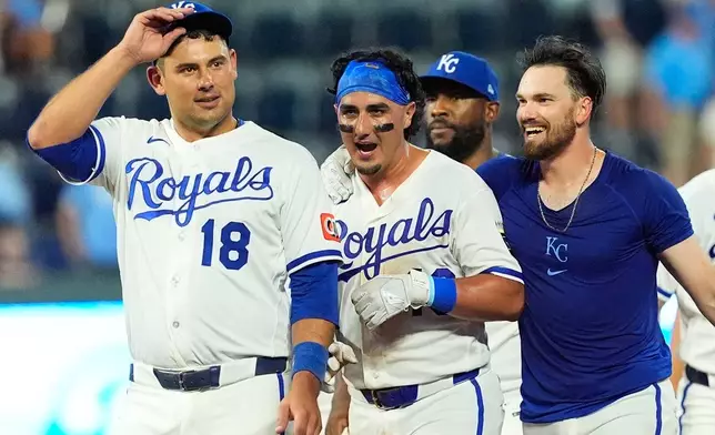 Kansas City Royals' Nick Loftin, right, celebrates with Josh Rojas, center, after Loftin hit a bunt single to drive Rojas in for the winning run during the ninth inning of a baseball game against the San Francisco Giants, Monday, July 20, 2026, in Kansas City, Mo. (AP Photo/Charlie Riedel)